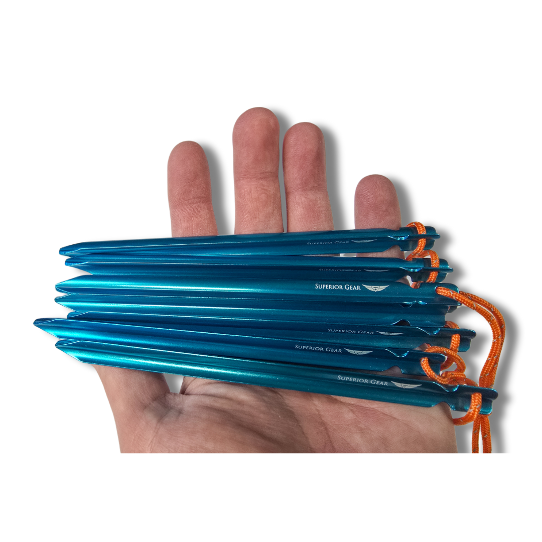 A man holding a pile of ground stakes.