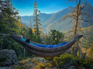 Insulated hammock set up on a mountain.