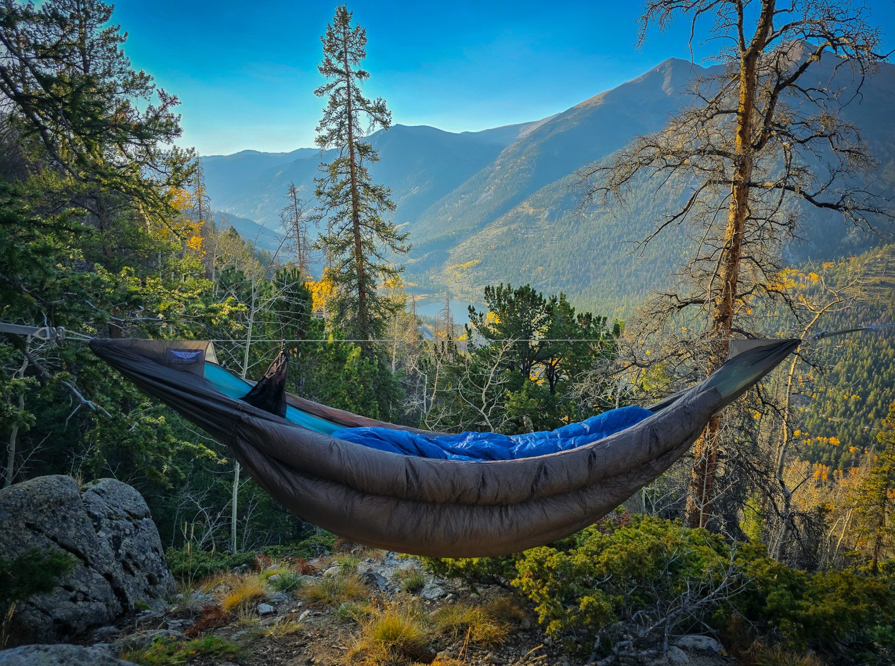 Insulated hammock set up on a mountain.